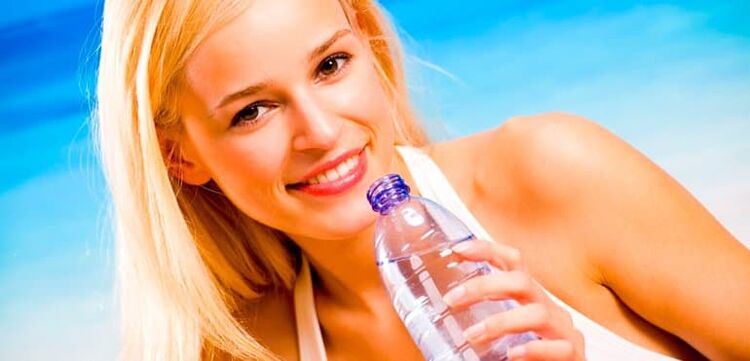 Girl drinking water during a drinking diet
